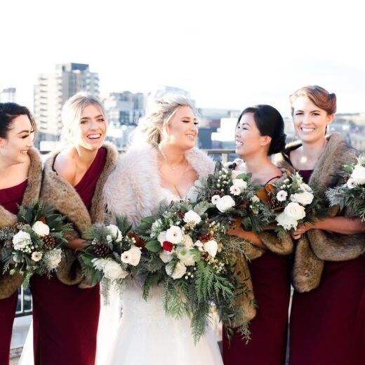 winter bridal party with bridesmaids wearing faux fur bridesmaid wraps