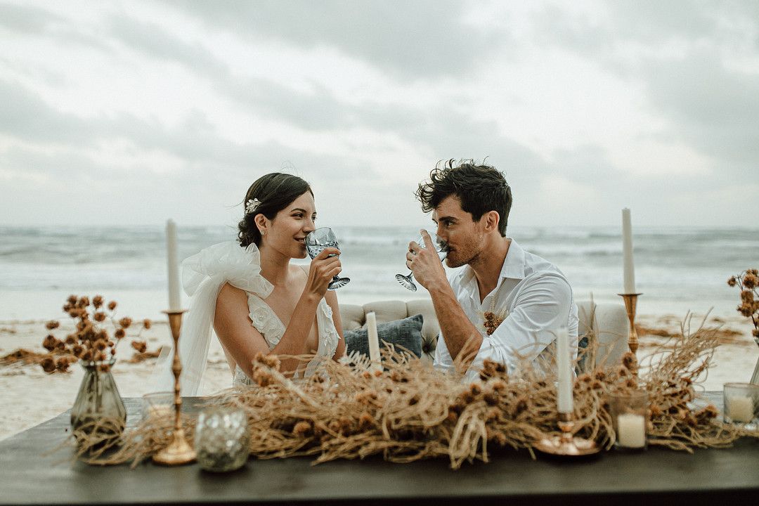 couple eating and drinking at elopement in tulum