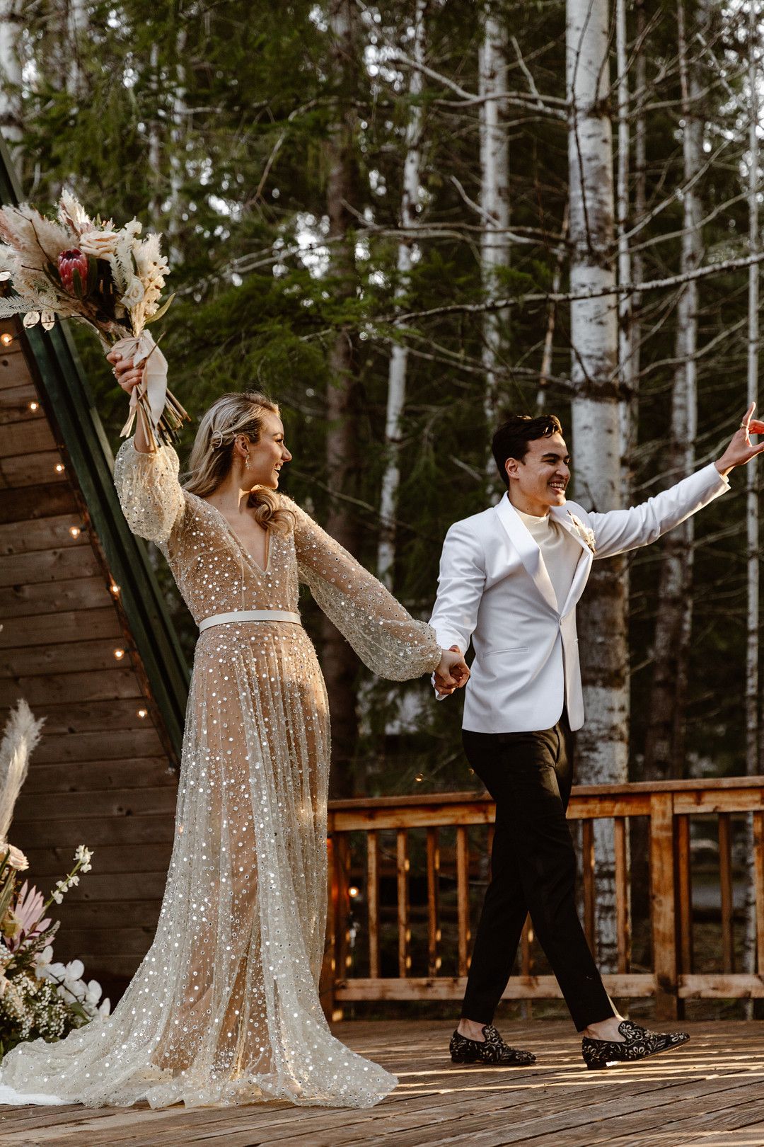 bride and groom celebrating at intimate cabin elopement