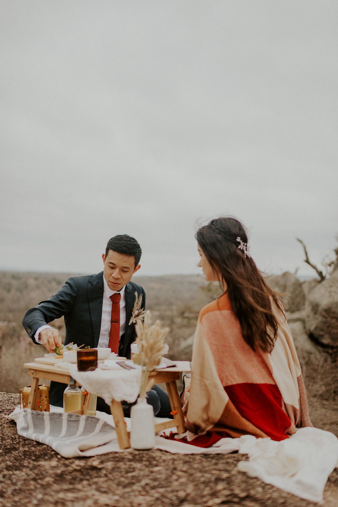 bride and groom having a picnic