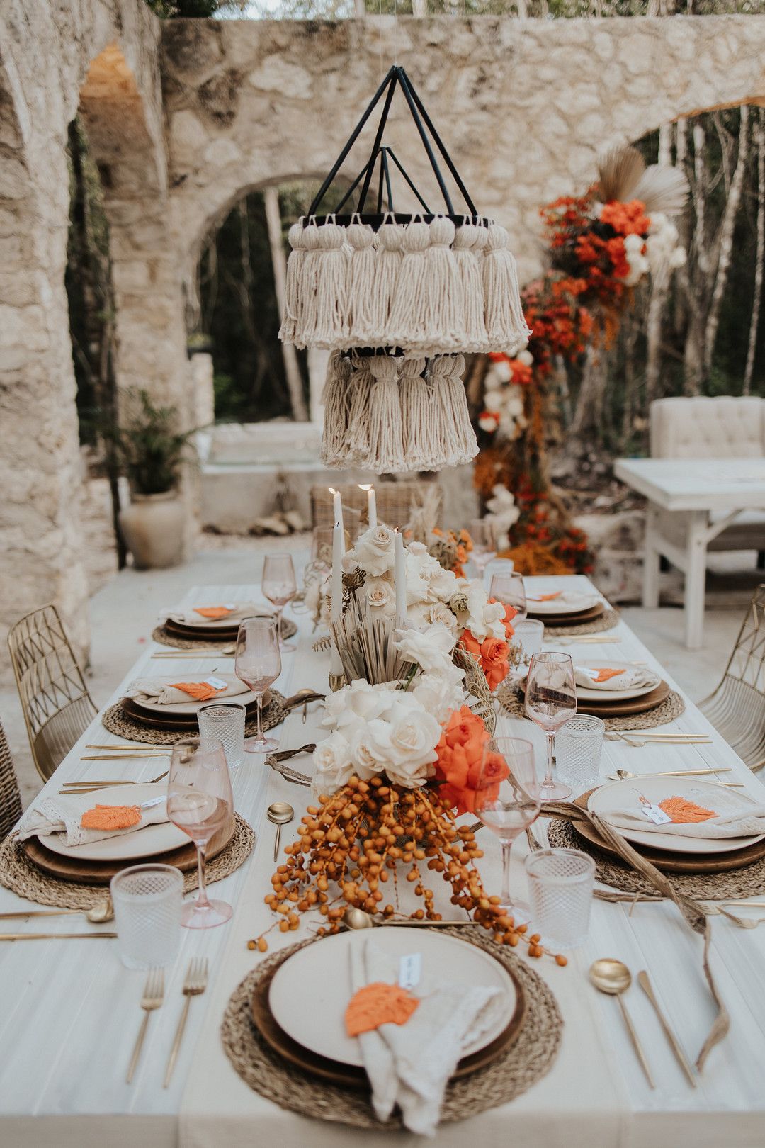 bohemian wedding table decor with pops of orange 
