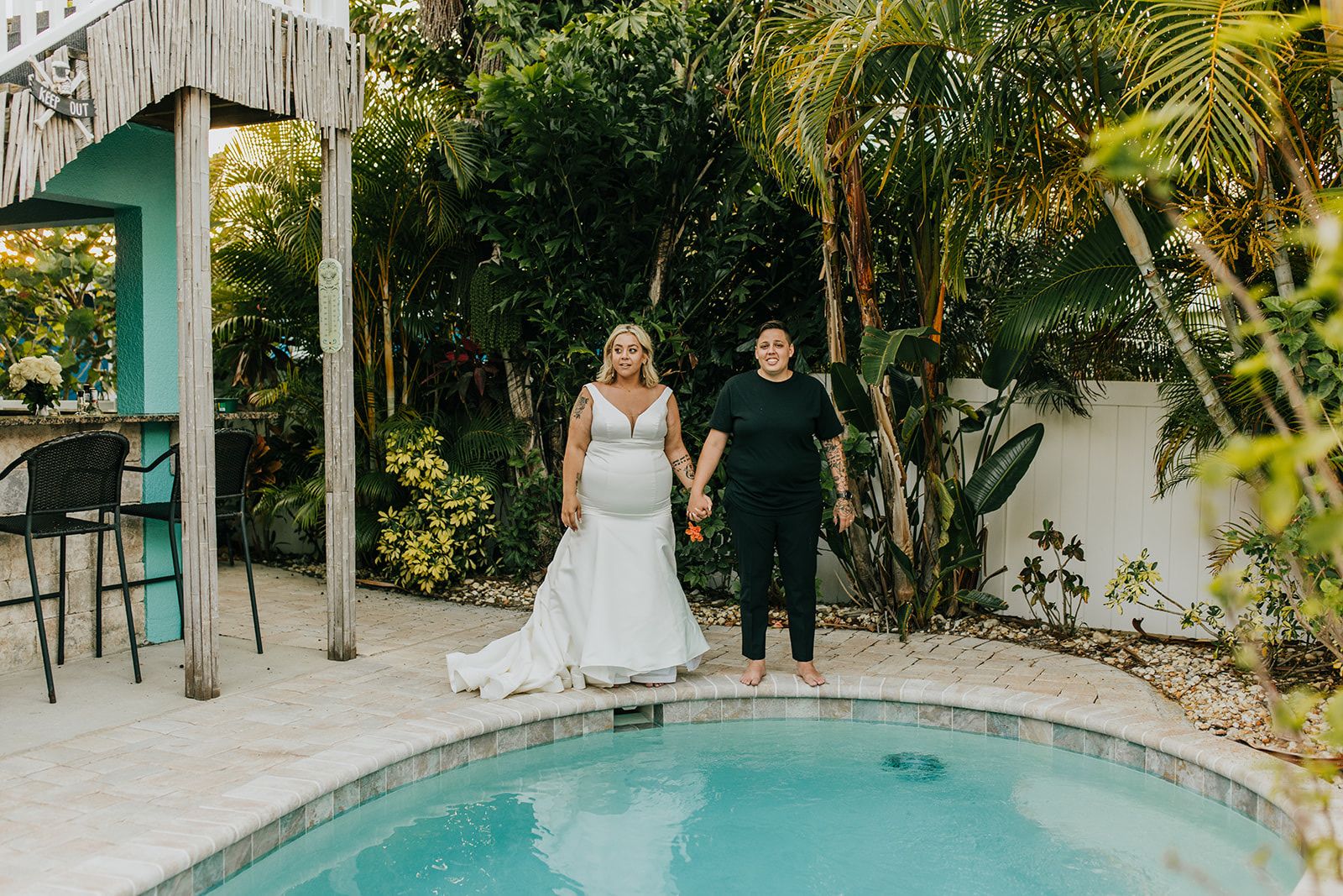 two brides jumping into pool