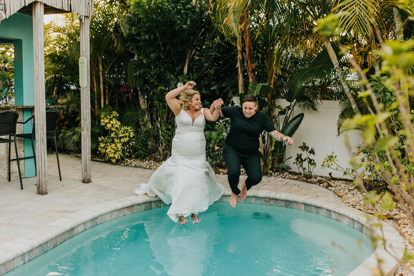 two brides jumping into pool
