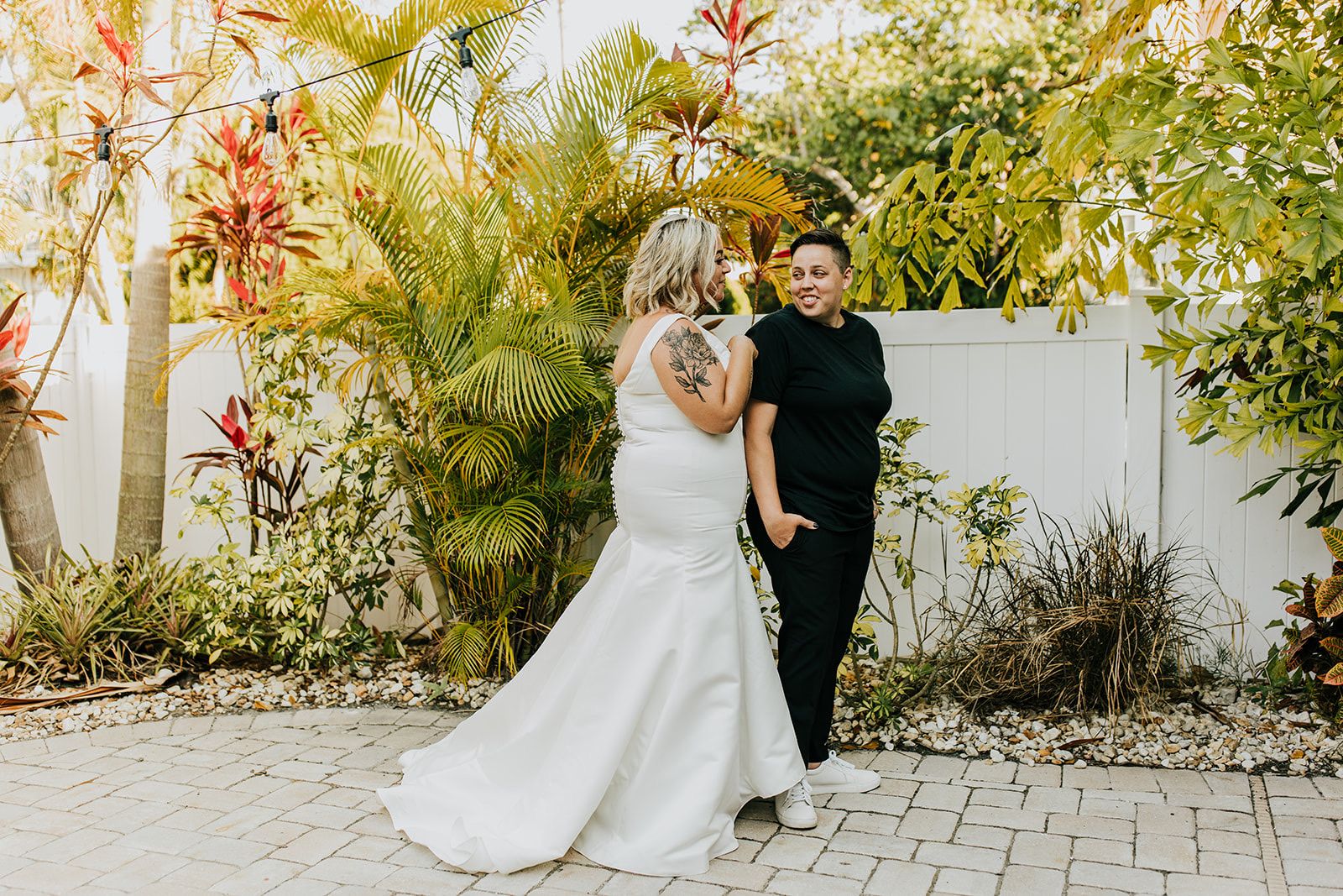 two brides embracing at intimate oceanside wedding