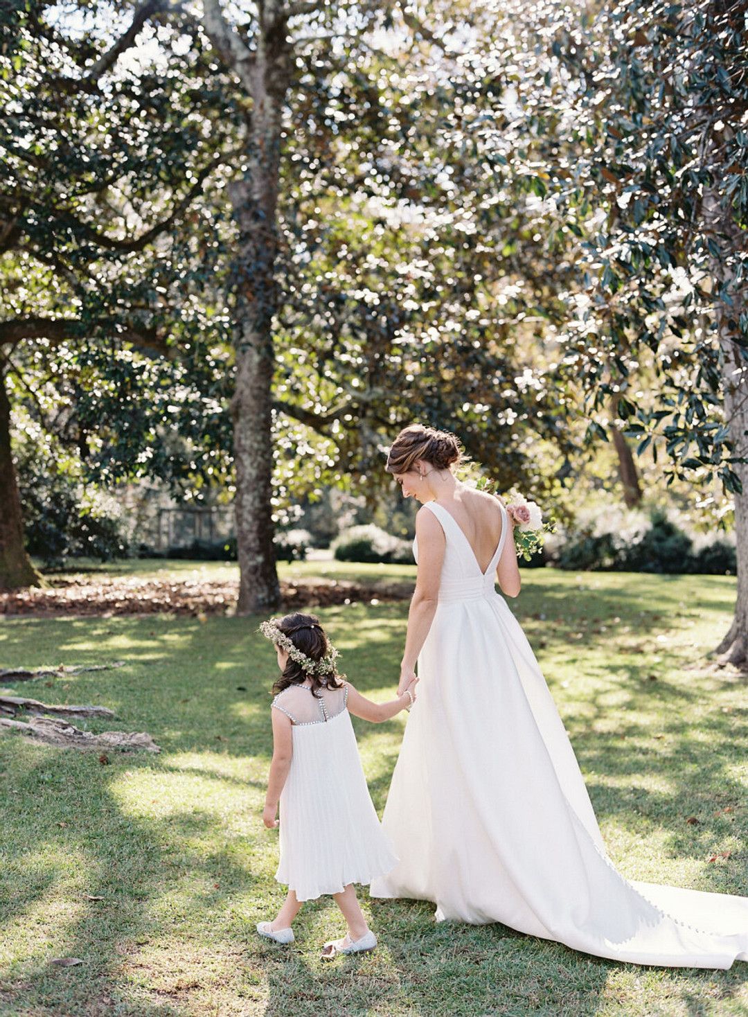 bride and flower girl walking at fall wedding in south carolina
