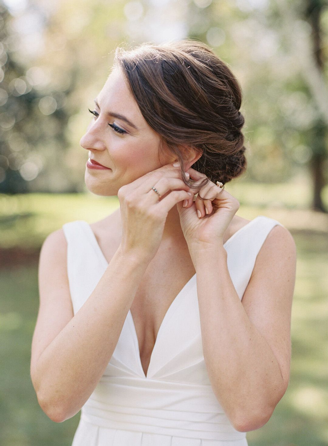 bride putting on earring