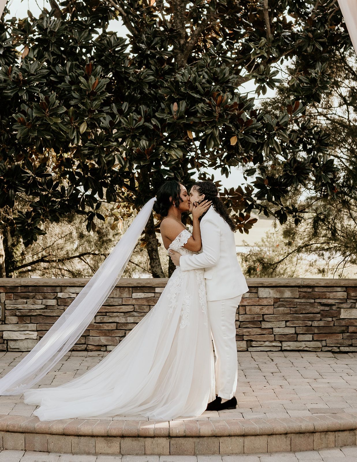brides kissing at intimate fall wedding