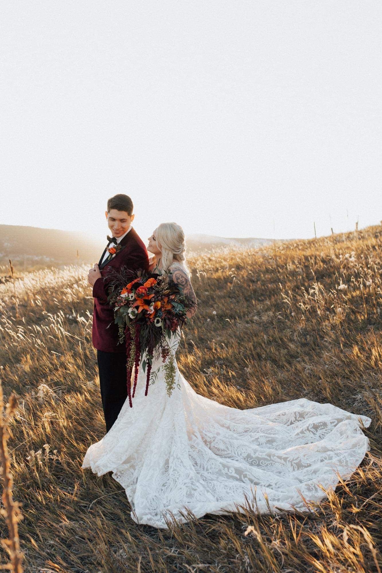 bride and groom embracing at dreamy outdoor fall wedding