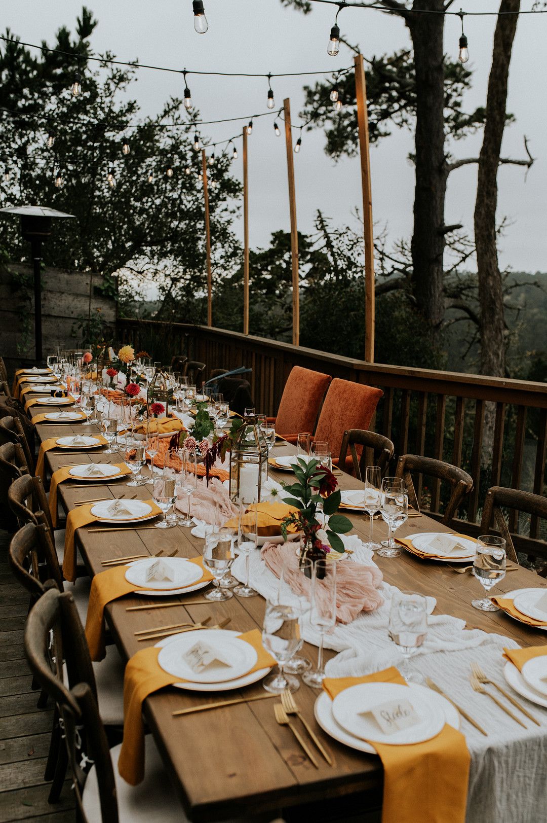 Sunset hue wedding table decorations for a coastal wedding in Big Sur