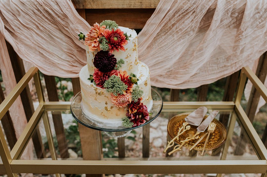 Vibrant floral wedding cake on table