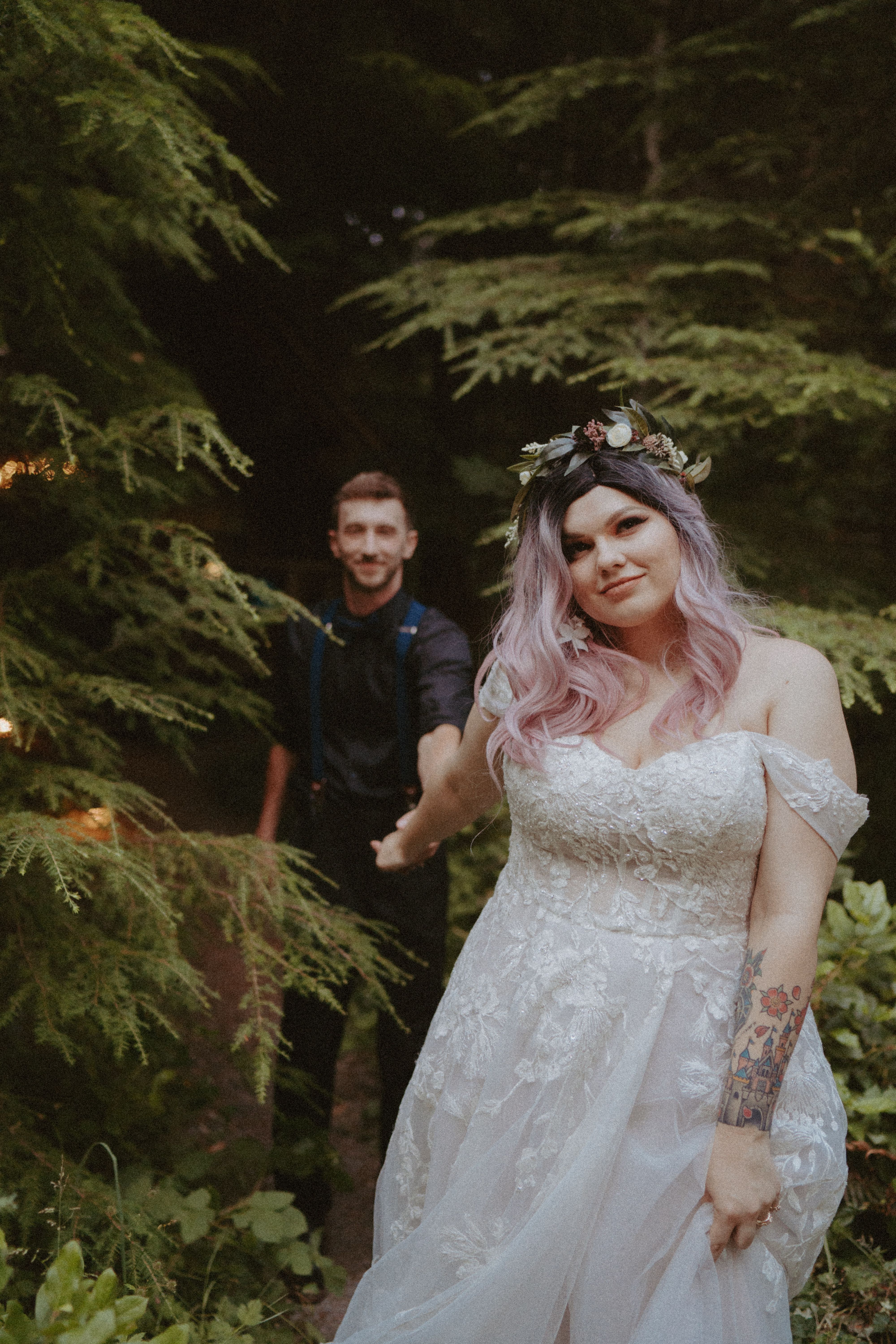 bride and groom walking through woods at mount rainier wedding