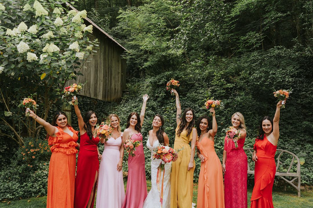 bride and bridesmaids wearing brightly colored dresses