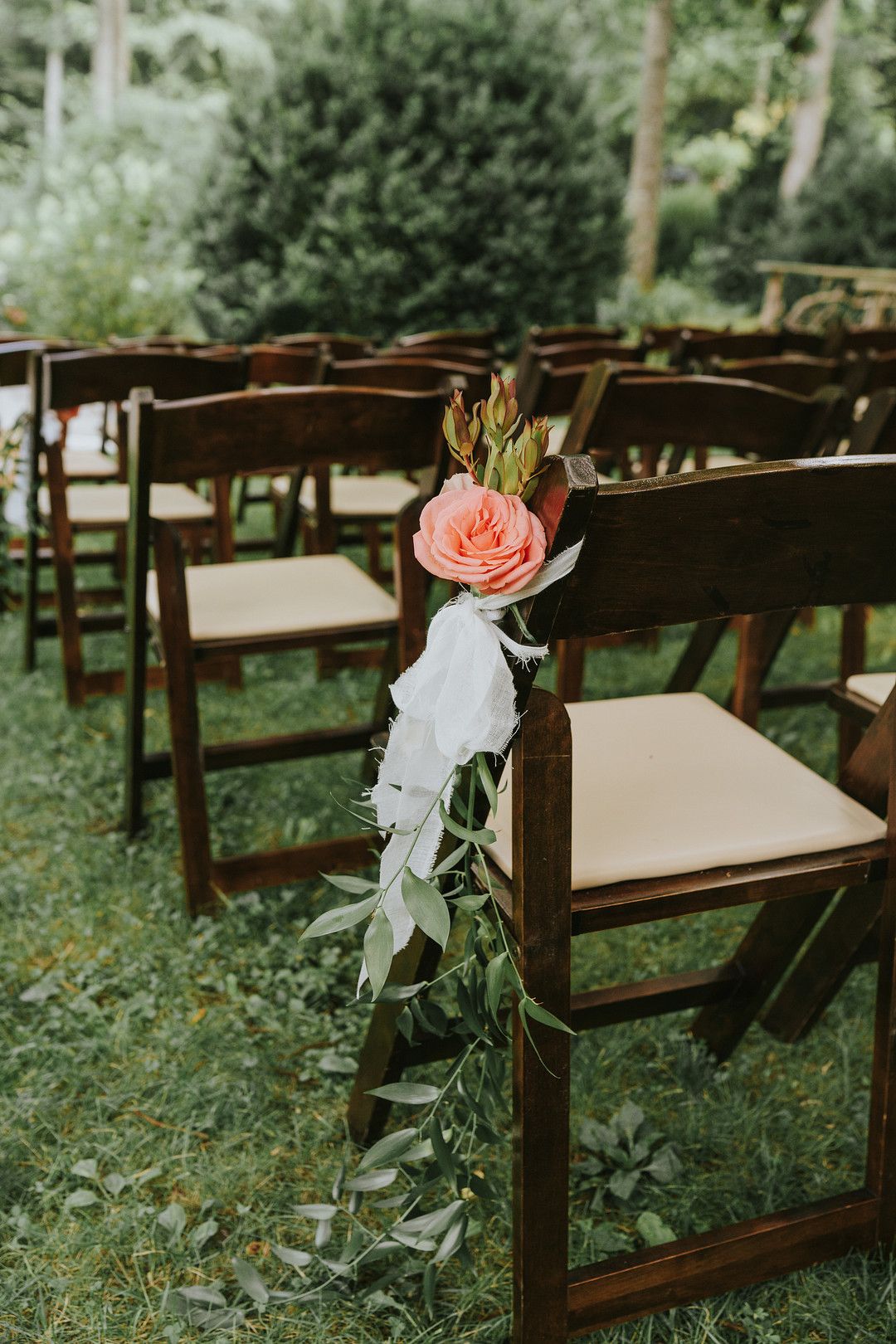 flower decor hanging on wedding ceremony chair