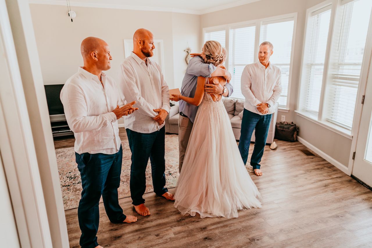 Bride hugging Dad before wedding ceremony