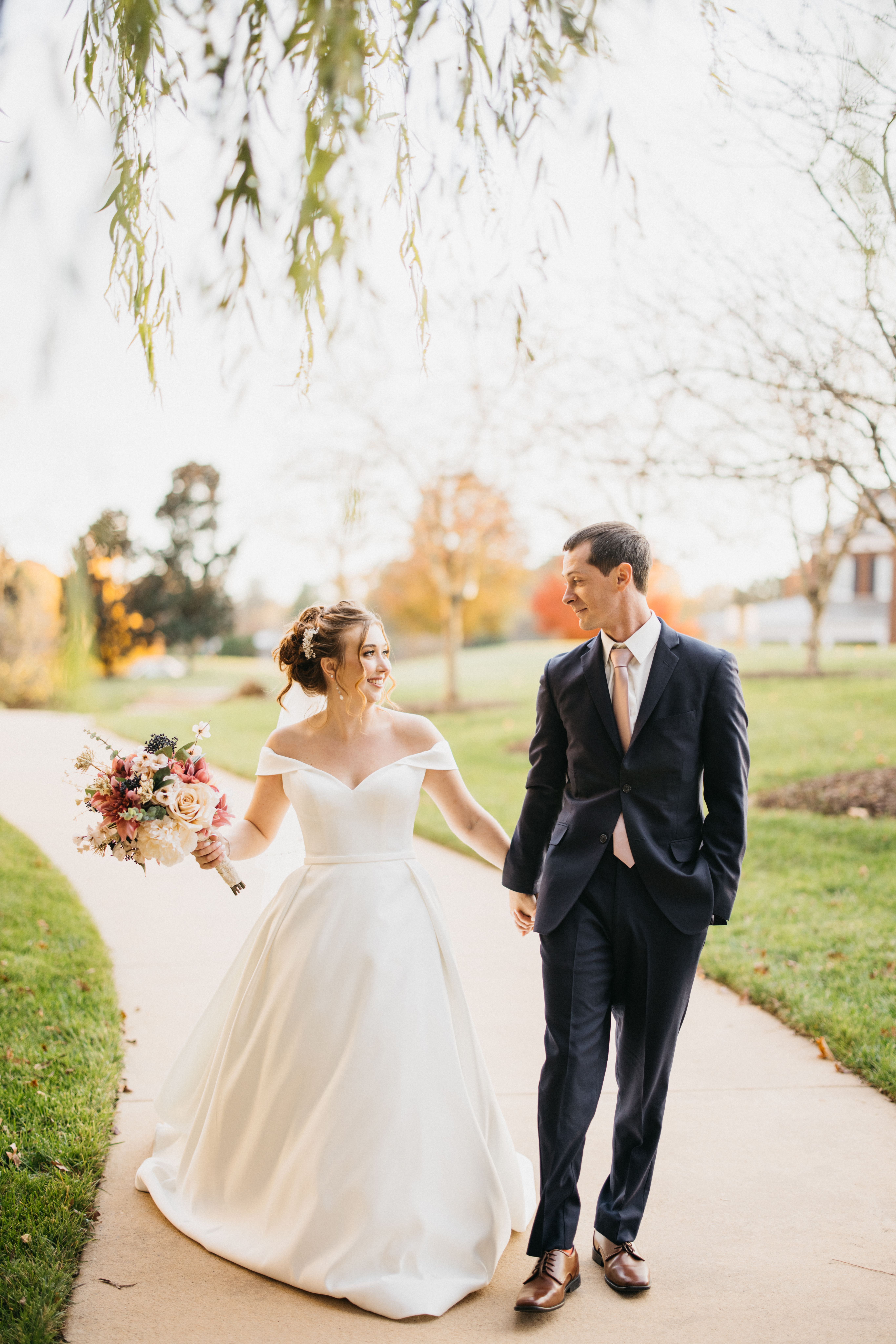 bride and groom walking together at fall wedding in north carolina