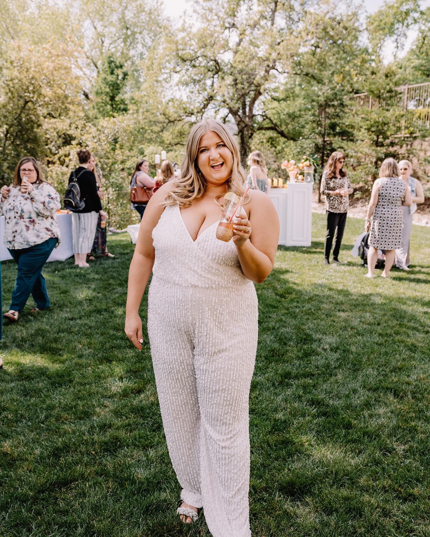 bride at bridal shower wearing a sparkly white jumpsuit