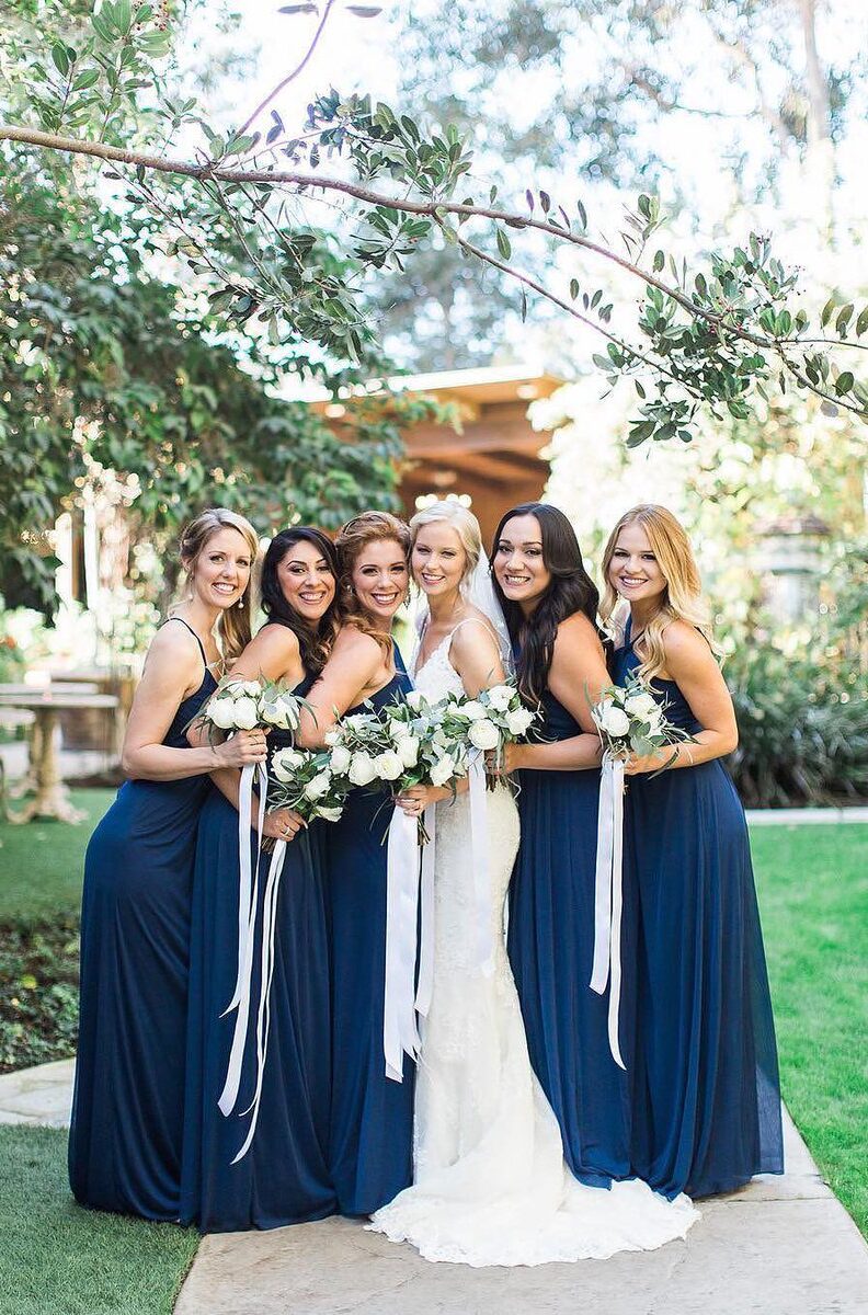 bride with bridesmaids wearing blue dresses
