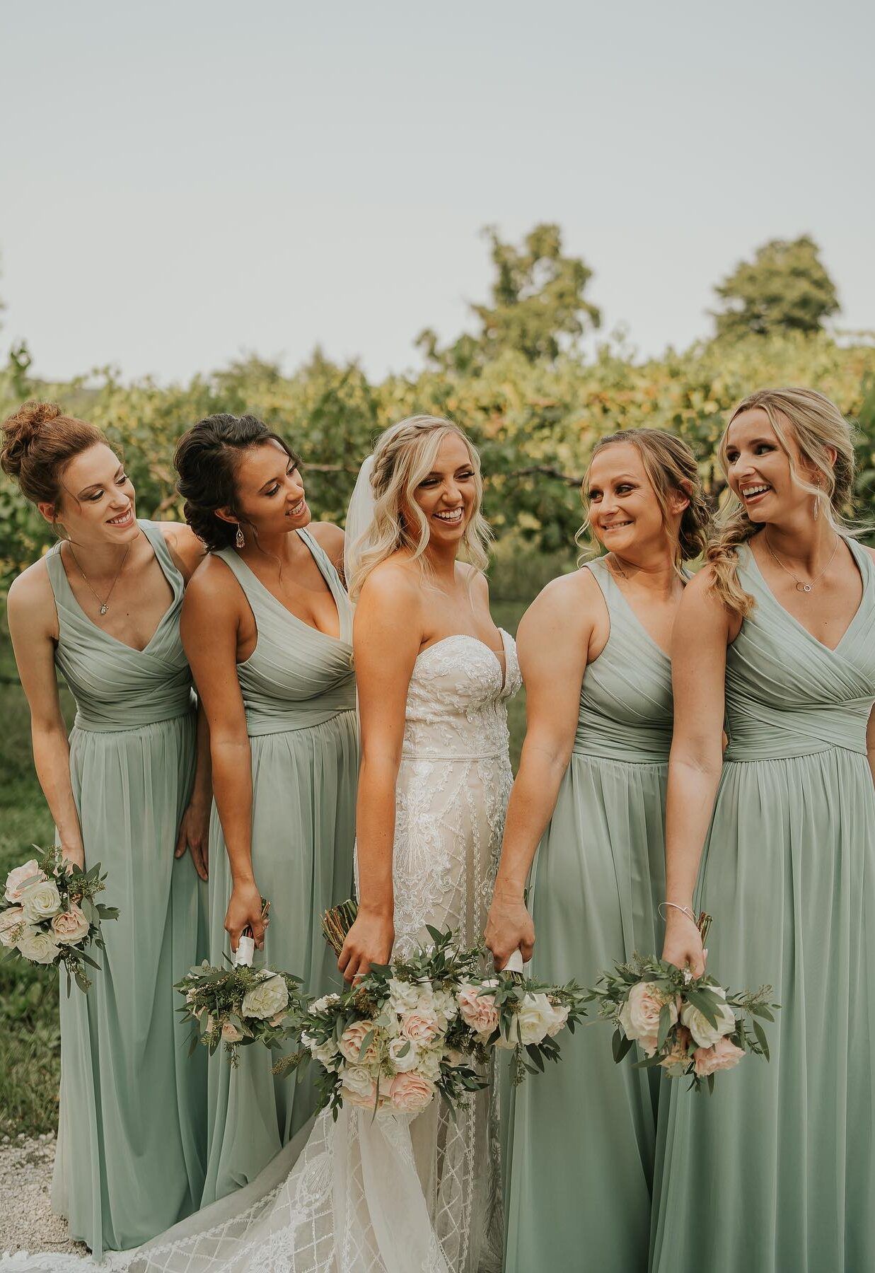 bride and bridesmaids wearing color coordinating dresses