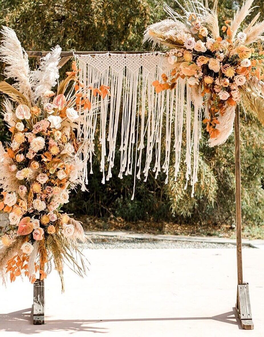 wedding arch backdrop with orange florals