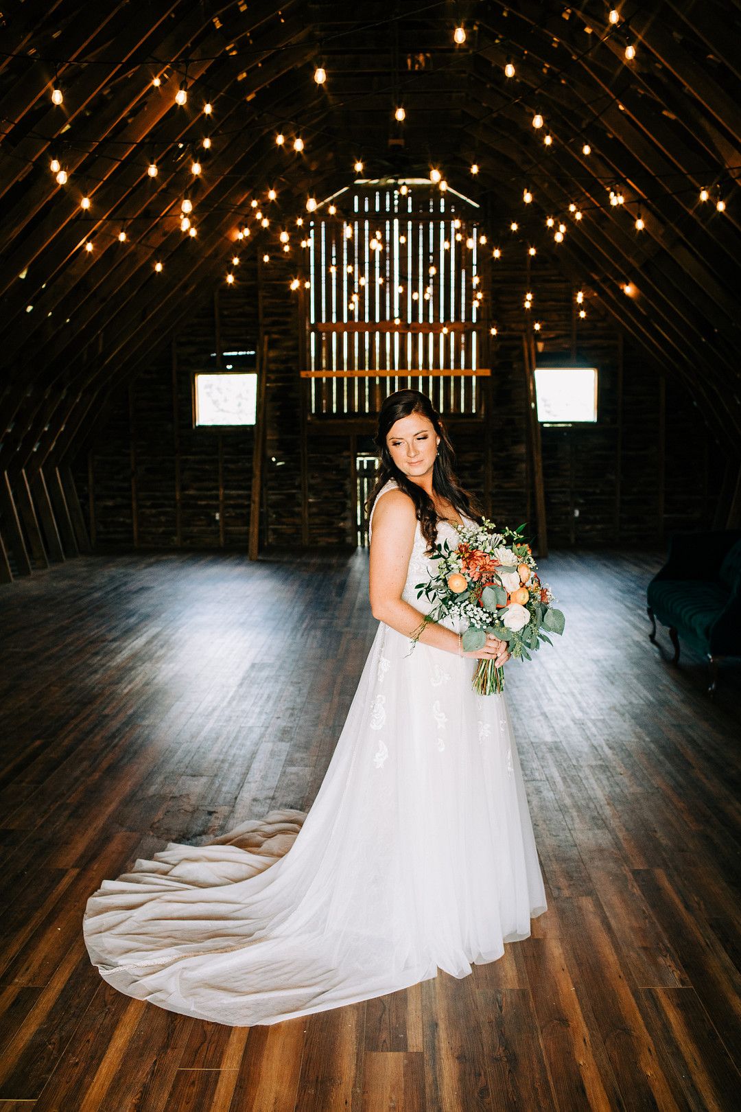 bride posing in barn