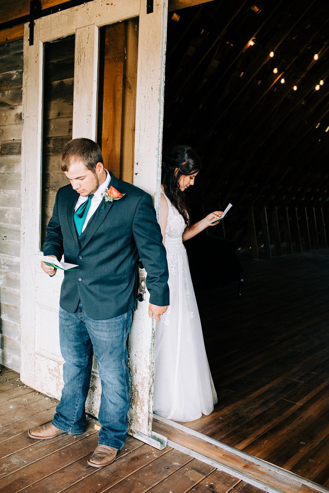 bride and groom reading vows at rustic barn wedding