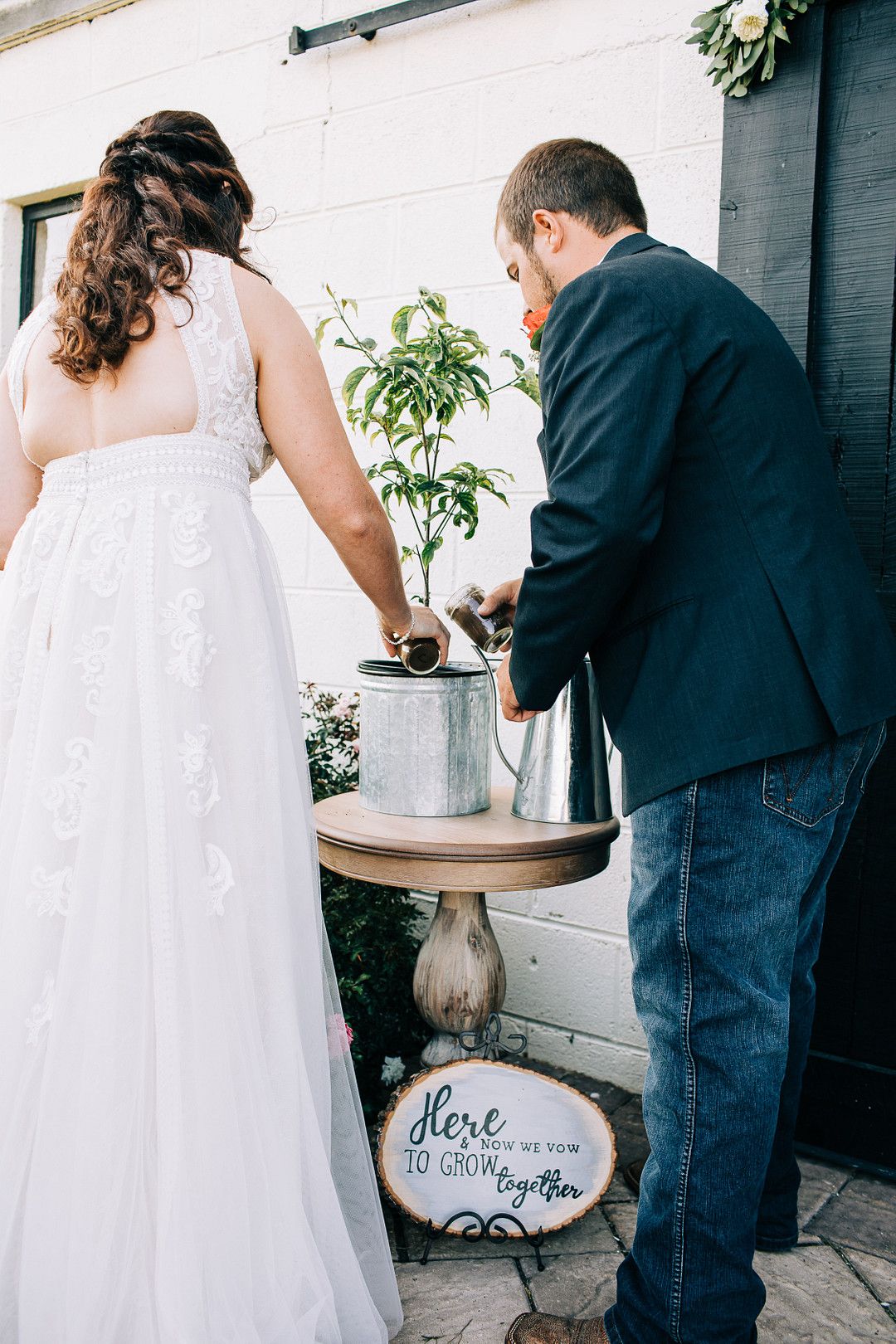 bride and groom planting a tree